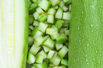 Zucchini or courgette whole, sliced and cut into cubes. Fresh raw vegetable, top view, macro photography