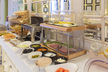 Breakfast served on buffet table in hotel restaurant