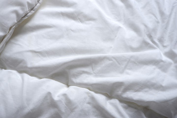 Texture of a white blanket.  Soft white bed linen. Background. Texture. Minimalism.