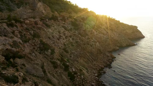 Aerial view of Cala Llonga beach, located in southern Ibiza, Spain. Beautiful aerial view of the bay at sunset