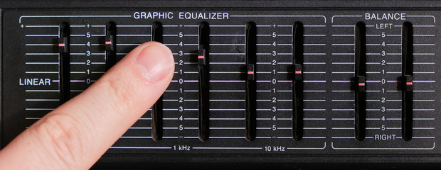 Adjusting the sound frequency balance using equalizer faders.