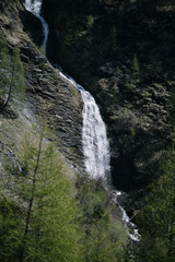 Fototapeta na wymiar Waterfall in the alpine mountains.