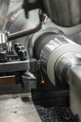 Produces metal detail in factory. Machine tools for metal working. A metal workpiece is machined by an electric machine. Cutting metal modern processing technology. Coolant and lubrication.