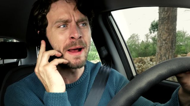 Closeup of angry man screaming on the phone while driving furious about financial problems after end of corona virus quarantine