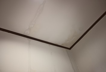 Water marks from the ceiling, water flows from the edge of the ceiling to the wall Moisture from...