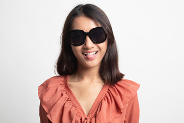 Portrait of a beautiful young asian girl in sunglasses .