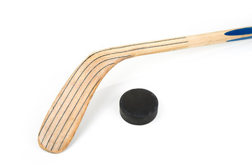 Ice hockey stick and puck on a white