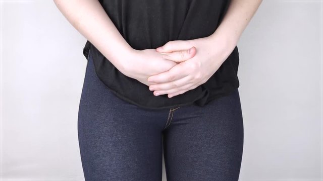 A woman suffers from pain in the pelvic organs. The gynecologist examines the patient. Painful location, female disease, cystitis, or urinary incontinence