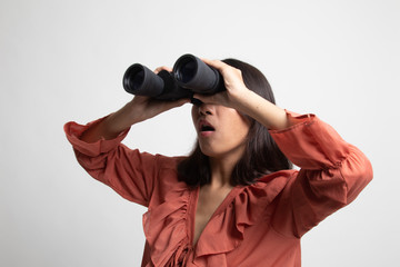 Young Asian woman with binoculars .