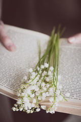 lilies of the valley and a book