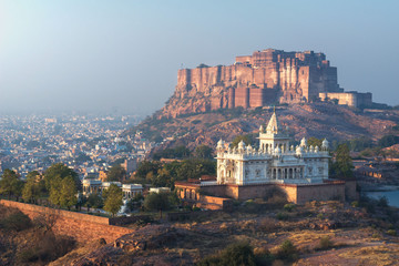 .India, Jodhpur, city scape at sunset of Blue city and Mehrangarh Fort a UNESCO World Heritage Site with Jaswant Thada in the foreground. - 353429459
