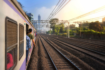 Mumbai, India, Due to overcrowding, people travel in open doors. Mumbai Suburban Railway known as Super-Dense Crush Load and most severe overcrowding in the world - 353430093