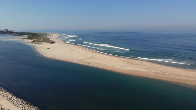 DRONE The two sides of Restinga de Ofir. One facing the ocean, the other the estuary of C&aacute;vado River. The jetty structure that protects the coastline from the currents and tides in Esposende, Portugal