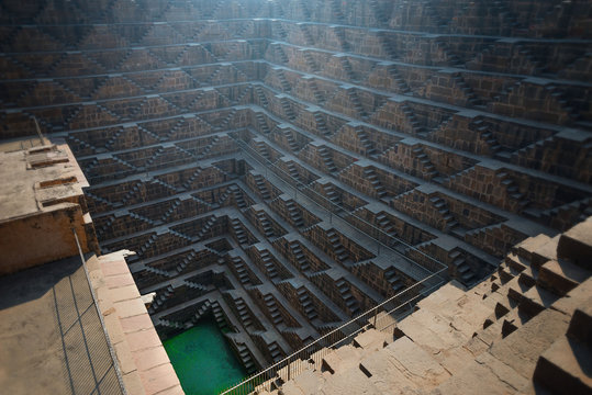 .Perspective stone stairs of the famous and deepest Chand Baori Step Well in Abhaneri, Rajasthan, India. Stepwells in which the water is reached by descending a set of steps to the water level