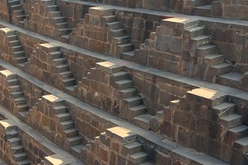 .Perspective background of stone stairs of Chand Baori Step Well in Abhaneri, Rajasthan, India. Stepwells in which the water is reached by descending a set of steps to the water level