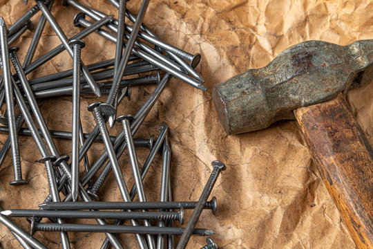 Vintage hammer with nails on papper