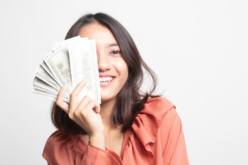 Portrait of  young asian woman  showing bunch of money banknotes .