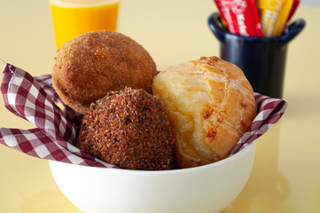tasty brazilian snack and fresh juice on a yellow background
