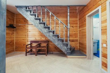 Wooden stairs and walls in simple eco house interior