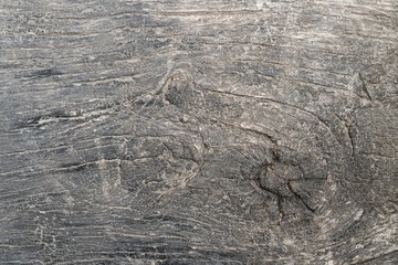 Background image of dark wood texture. Board with a large pattern of fibers for construction and finishing works, furniture production. Texture element with wood knot