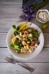 Poached Salmon salad with baby potatoes  and yogurt dressing. Overhead vertical image