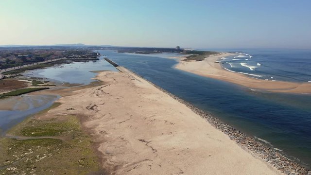 DRONE The two sides of Restinga de Ofir. One facing the ocean, the other the estuary of C&aacute;vado River. The jetty structure that protects the coastline from the currents and tides in Esposende, Portugal