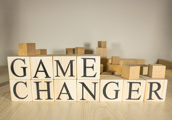 Game changer text on wooden cube blocks. Close up.
