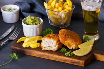 Traditional fish and chips with mushy peas and glass of beer
