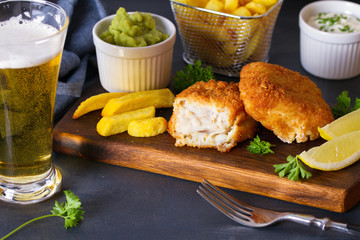 Traditional fish and chips with mushy peas and glass of beer