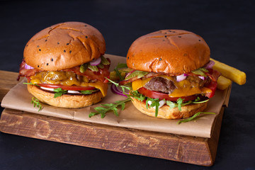 Beef burgers and french fries on serving board. Street food, fast food