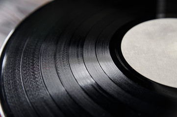 Segment of vinyl record with label showing the texture of the grooves, retro look