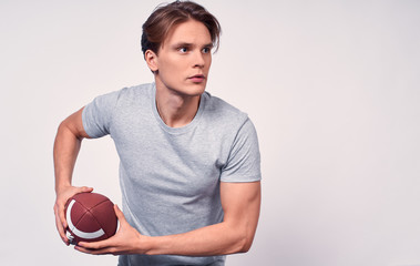 A young football player ready to throw his football. © Svitlana