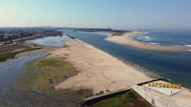 DRONE The two sides of Restinga de Ofir. One facing the ocean, the other the estuary of C&aacute;vado River. The jetty structure that protects the coastline from the currents and tides in Esposende, Portugal