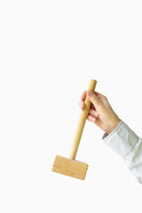 Wooden hammer for meat in a female hand on a white background