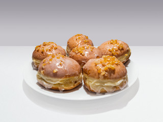 The tasty donuts on the plate for a fat Thursday. 