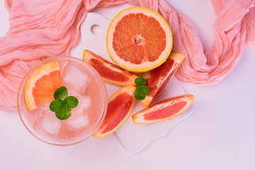 Grapefruit cocktail, drink with ice and mint on a white background.