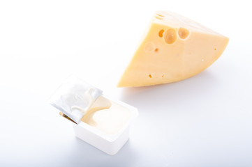 A package of cheese sauce and a piece of hard cheese. Cheese seasoning. - obrazy, fototapety, plakaty
