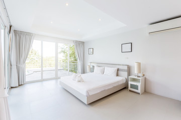 Fototapeta na wymiar Modern bed room interior in Luxury villa. White colours, big window