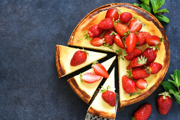 Vanilla cheesecake with strawberries on a black concrete background. Top view.Advertising. Restaurant menu.