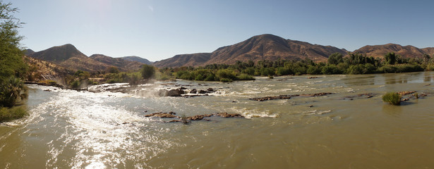Epupa Falls Waterfall bush landscape on the border of Angola and Namibia, in the Kaokoland area of...