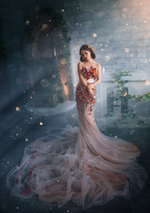 Fantasy beauty woman princess. glamorous peach creative dress long train. Fashion model posing in fairy room full magical divine light. Mystic art photo image of Queen Goddess Butterfly. Golden tiara