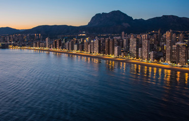 Fototapeta premium Night city by the sea with an empty beach and beautiful night lighting, Summer background