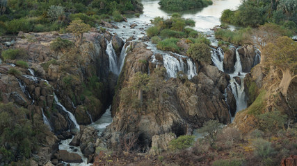 Epupa Falls Waterfall bush landscape on the border of Angola and Namibia, in the Kaokoland area of...