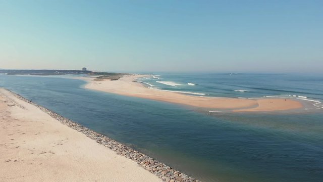 DRONE The two sides of Restinga de Ofir. One facing the ocean, the other the estuary of C&aacute;vado River. The jetty structure that protects the coastline from the currents and tides in Esposende, Portugal