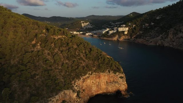 Aerial view of Cala Llonga beach, located in southern Ibiza, Spain. Beautiful aerial view of the bay at sunset
