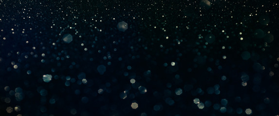 Christmas light background.  Holiday glowing backdrop. Defocused Background With Blinking Stars. Blurred Bokeh.