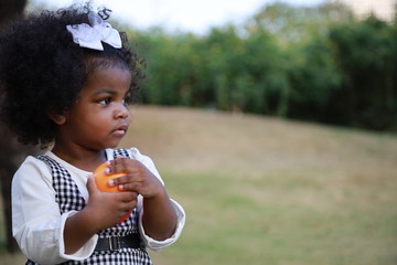 Portrait of Cute kid hand holding a ball at the garden