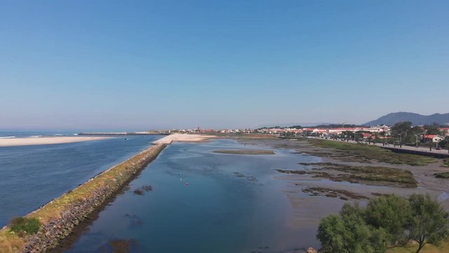 DRONE The two sides of Restinga de Ofir. One facing the ocean, the other the estuary of C&aacute;vado River. The jetty structure that protects the coastline from the currents and tides in Esposende, Portugal