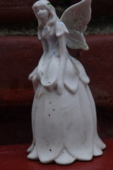 Angel Figurine by a Brick Wall