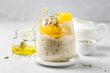 Coconut cream overnight oatmeal breakfast in glasses. Slective focus, copy space.